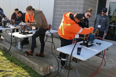 Image of participants doing hands on training on equipment during a Maintenancefest